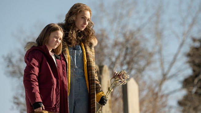 A still from Fargo, showing Dorothy Lyon and her daughter holding flowers