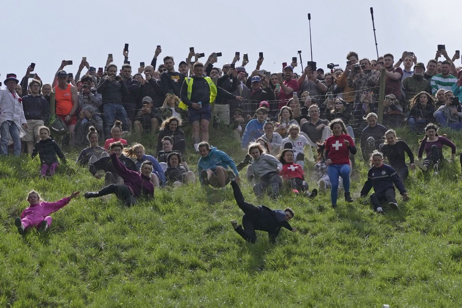 Runners tumble at the start of a steep downhill race.