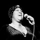 A black and white photo of Aretha Franklin singing