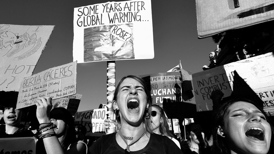 Demonstrators shout slogans during a global youth climate action strike in Madrid.