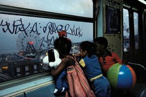 Kids looking out the window in the New York subway