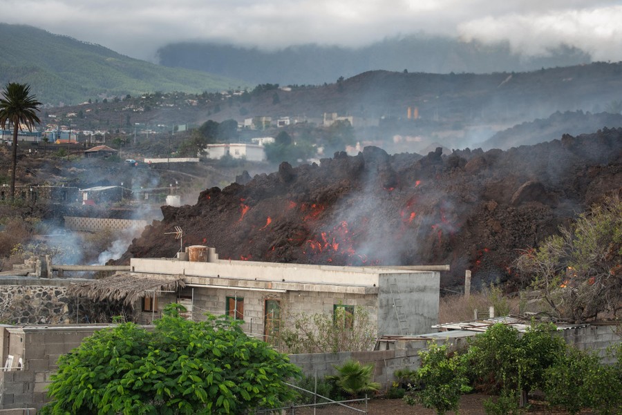 Cooling lava flows downhill through a neighborhood.