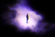 An illustration of a person's silhouette surrounded by a small amount of light