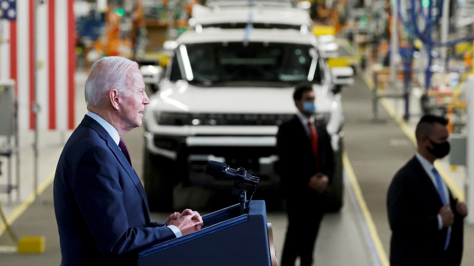 A photo of Joe Biden giving a speech in an auto factory