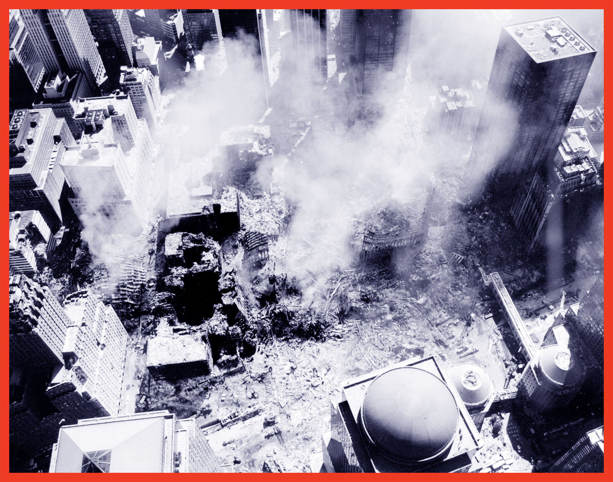 black-and-white aerial photo of smoking wreckage at World Trade Center in New York City