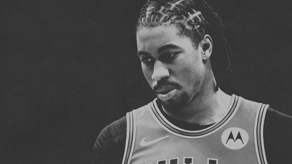 Black-and-white photo of the NBA player Jaden Ivey in a Bulls jersey with his eyes cast slightly downward.