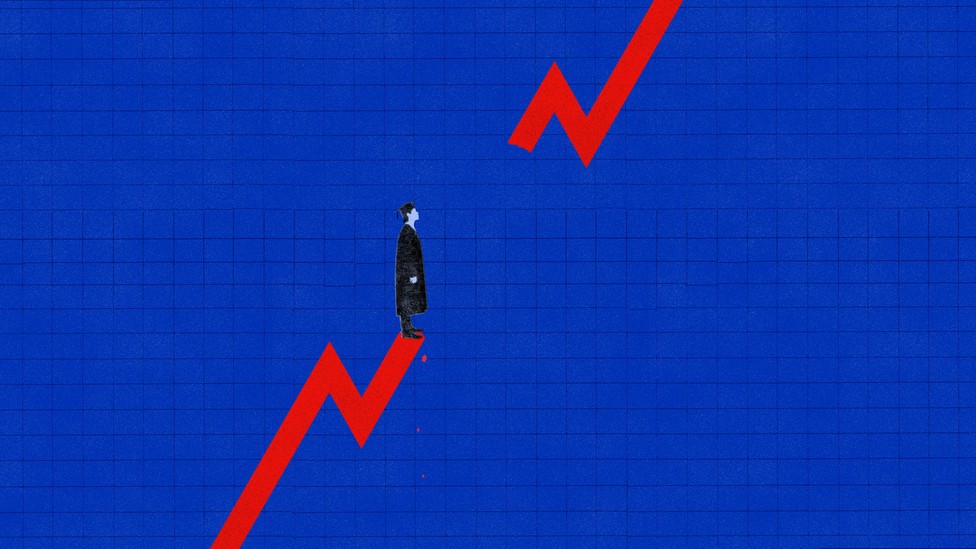 Man in graduation cap standing on trend line