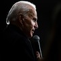 Picture of Joe Biden's profile, speaking to a microphone, a spotlight creating a backlight effect.