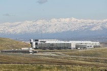 The NSA data center in Bluffdale, Utah, seen from a distance, with mountains in the background