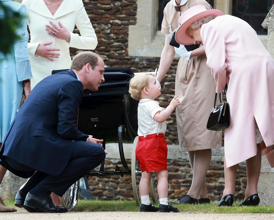 The Queen leans down to speak to her young great-grandson.