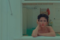 Scarlet Johansson stares intensely out the window of a bathroom in "Asteroid City."