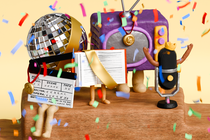 An illustration of a claymation TV, disco ball, microphone, book with a sash, and a clappberboard with legs sitting on top of a wooden platform