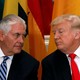 Donald Trump and Rex Tillerson are seated next to each other