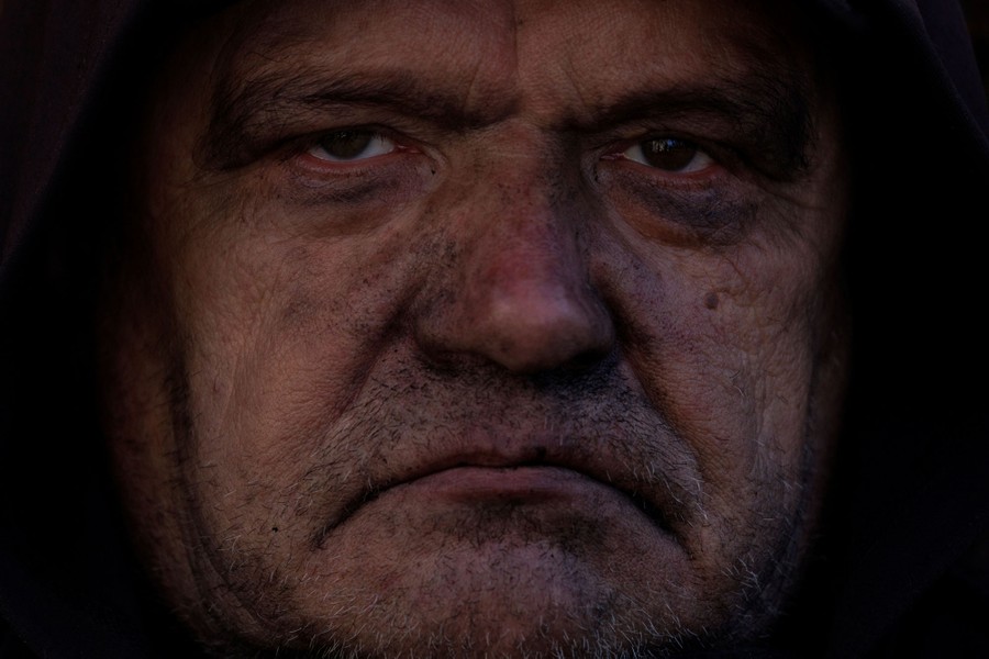 A person looks sternly toward the photographer.