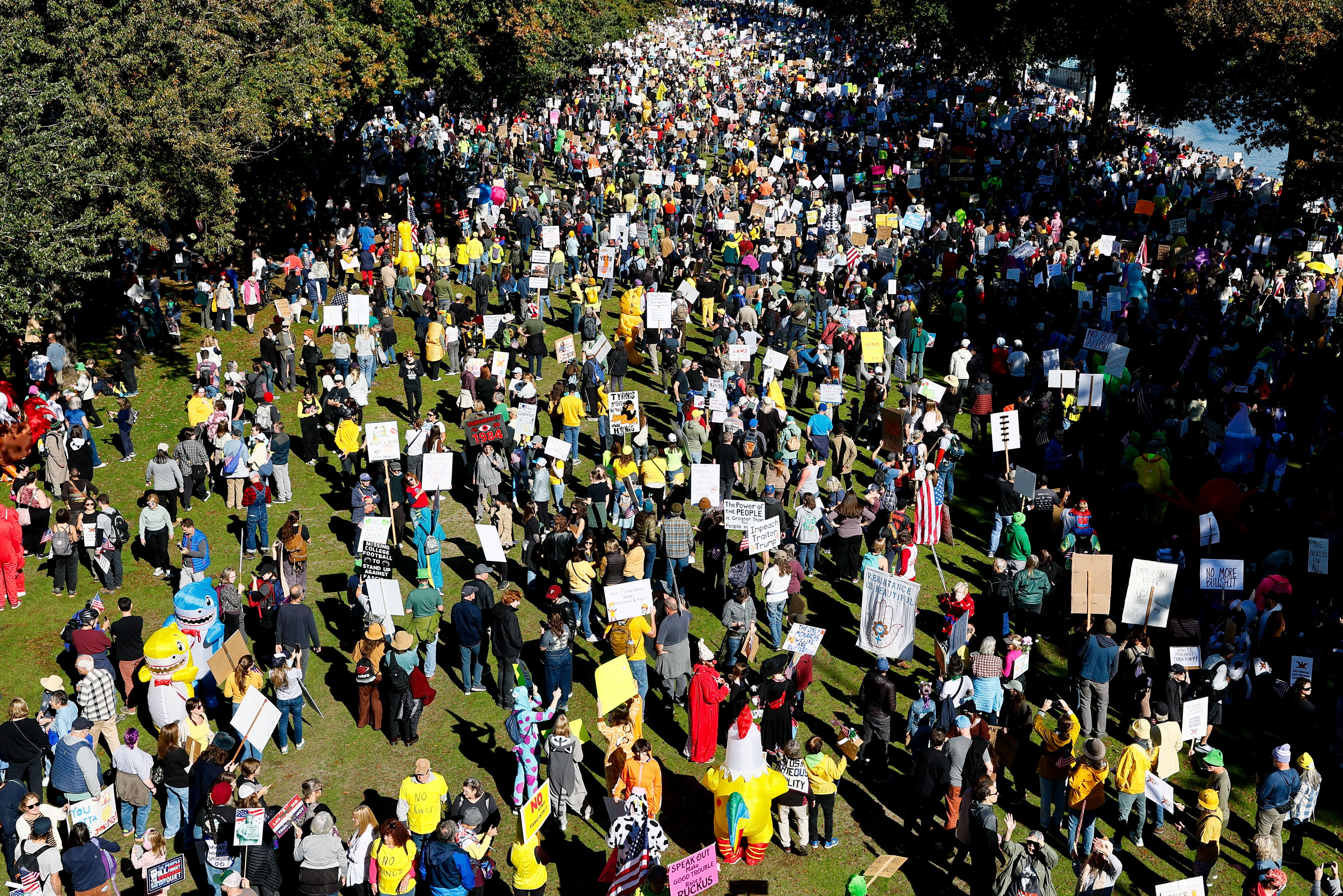 A large crowd of protesters gather in a park in Portland, Oregon, seen from above.