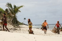 Season 33 of Survivor, showing people walking on a beach