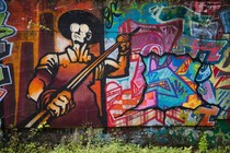 Graffiti, along with the figure of a steelworker, is painted on the side of Carrie Furnace blast furnaces in Rankin, Pennsylvania.