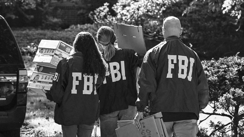 FBI agents remove boxes from John Bolton's house in Maryland.