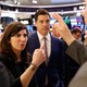 Stacey Cunningham in conversation with three men at the New York Stock Exchange 