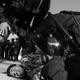 Black-and-white image of California Highway Patrol officers holding to the ground and arresting a demonstrator at the L.A. protests.