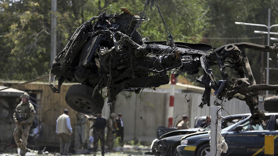 U.S. soldiers lift car wreckage with a crane in Kabul, Afghanistan.
