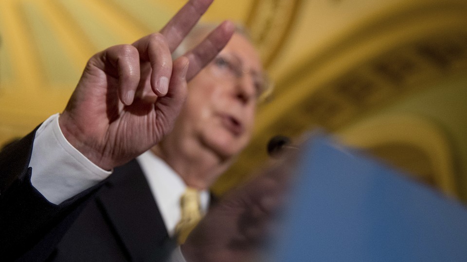 Senate Majority Leader Mitch McConnell gestures while speaking at a July news conference on Capitol Hill.