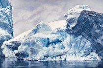 A realistic pastel drawing of glaciers or icebergs in water