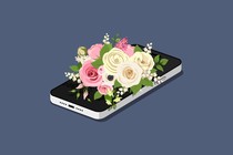 A smartphone under a bouquet of flowers