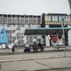 Two people sit at a bench in a Donbas town.