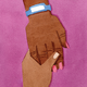 watercolor-style illustration of hand with painted nails and blue hospital ID bracelet on wrist being held by another hand on magenta background