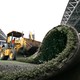 A truck removes artificial turf from a football stadium.