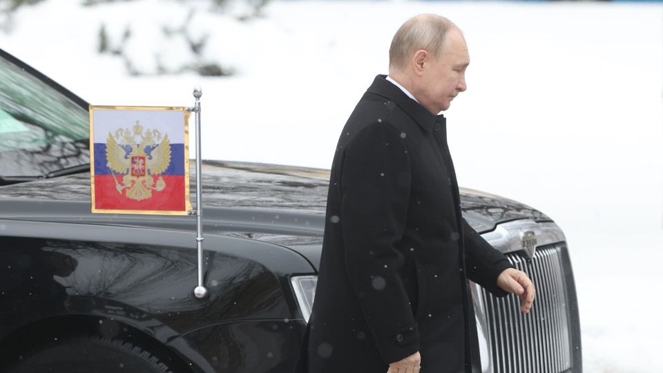 Russian President Vladimir Putin walks past his limousine
