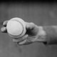 Black-and-white photo of a hand holding a baseball