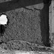 A black-and-white photo of a child playing in the ruins of a building in Afghanistan