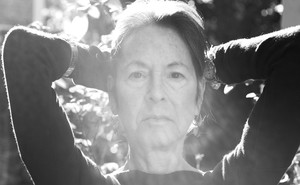A black-and-white photo of Louise Gluck in sunlight
