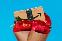 A graphic illustration of an Amazon box sitting in a bouquet of red flowers