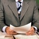 A newsreader before a microphone