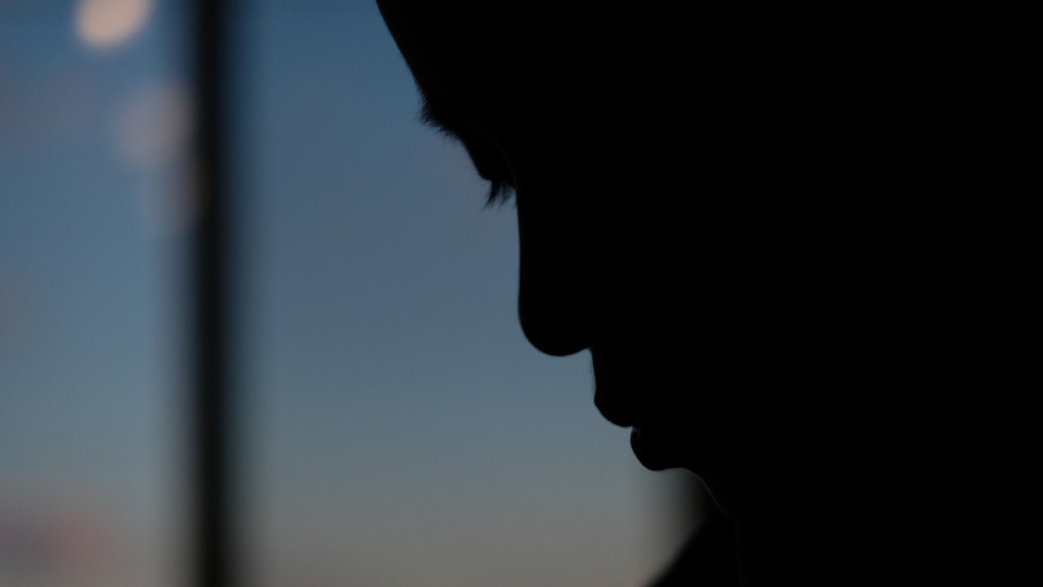 Silhouette of a boy looking down