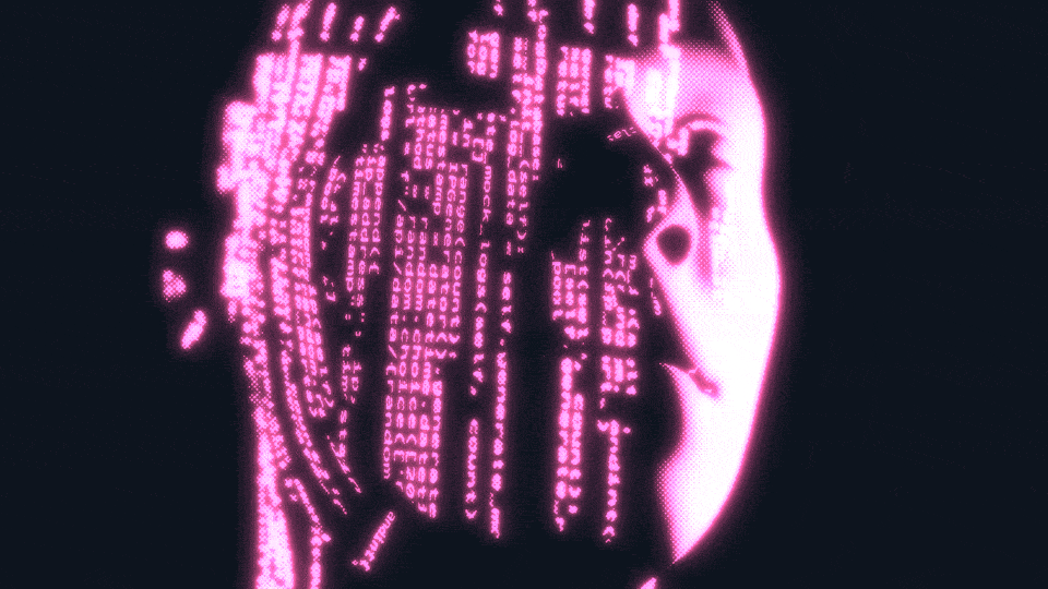 Computer code reflects on a human face.