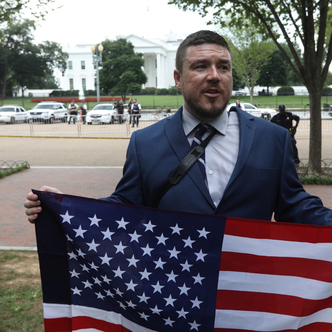 White South African man holds up a flag for the Afrikaner