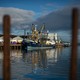 A fishing boat sits at a harbor on Britain's southern coast