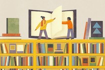Two women stand on top of a huge bookshelf, helping each other turn the page of a large book