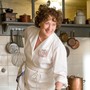 Meryl Streep in a white chef's outfit playing Julia Child