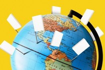 A globe with pins stuck into it; the flags on the pins are white books