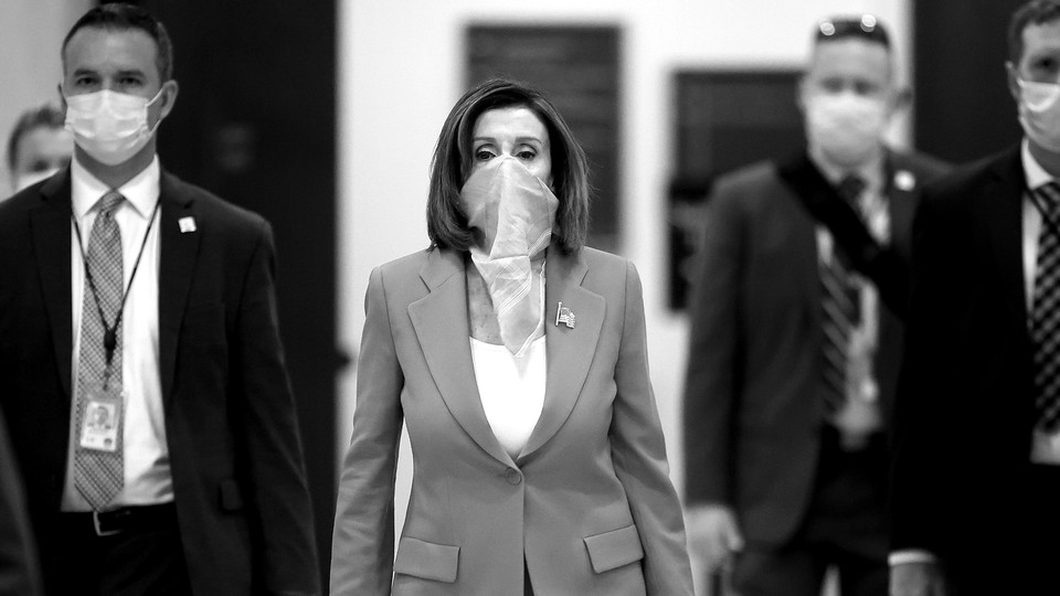 Nancy Pelosi wearing a scarf over her face.