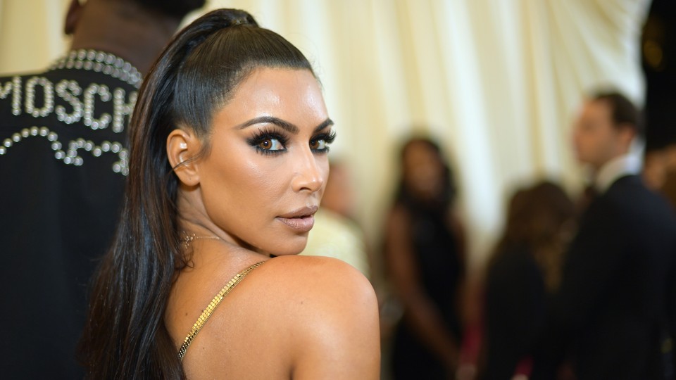 Kim Kardashian looks over her shoulder at the camera.