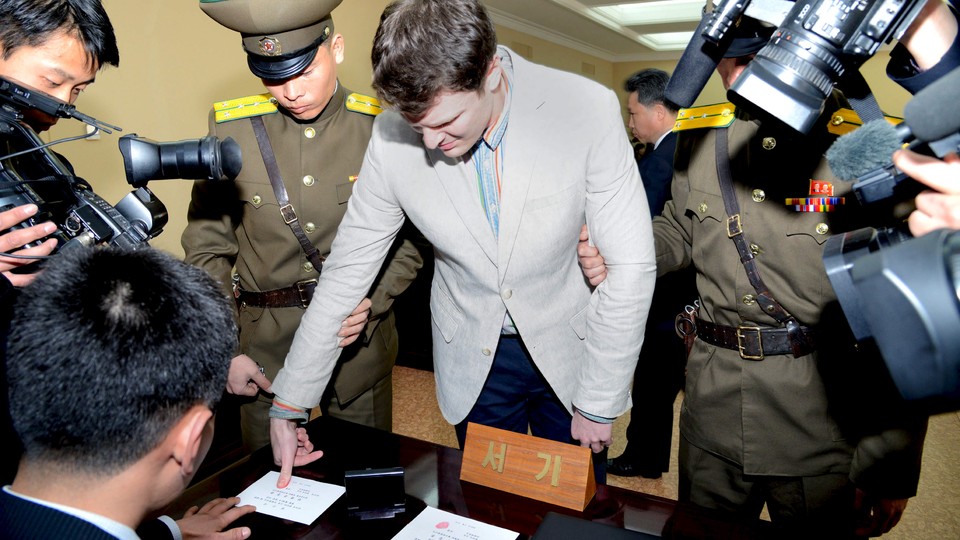 U.S. student Otto Warmbier has his fingerprints taken at North Korea's top court.