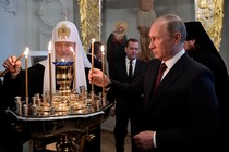 Vladimir Putin and Kirill, the patriarch of the Russian Orthodox Church, light candles at a ceremony at a monastery near Moscow in 2017.