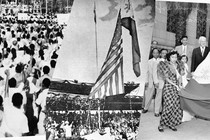 The Flag of the United States of America is lowered while the Flag of the Philippines is raised during the Independence Day ceremonies on July 4, 1946