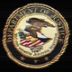 A distorted, crackly version of the Department of Justice seal